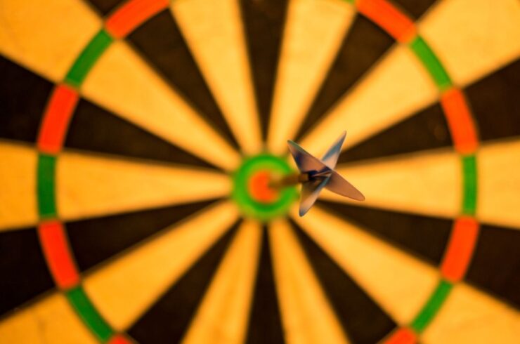 a dart on the bullseye of a dart board