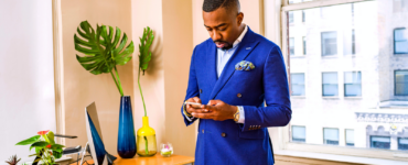 man in suit looking at his phone in his office accountability